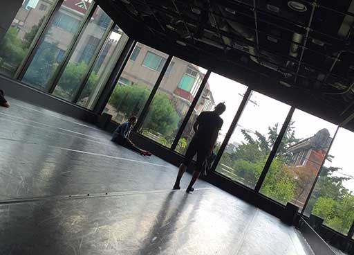 dance studio with floor to ceiling windows showing gardens outside