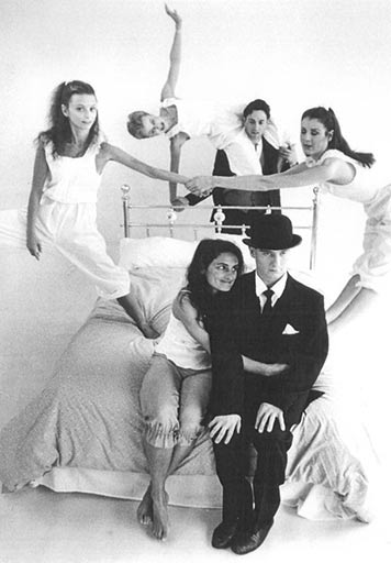 Five Dublin Contemporary Dance Theatre performers sit, stand and dance on a metal-framed double bed.